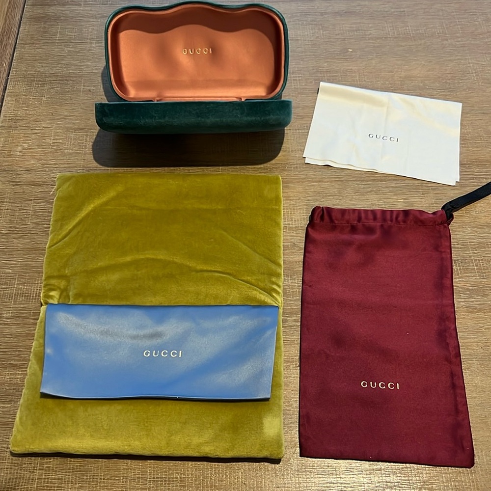 Gucci hard and soft sunglasses cases with dust cloth and silk storage bag.